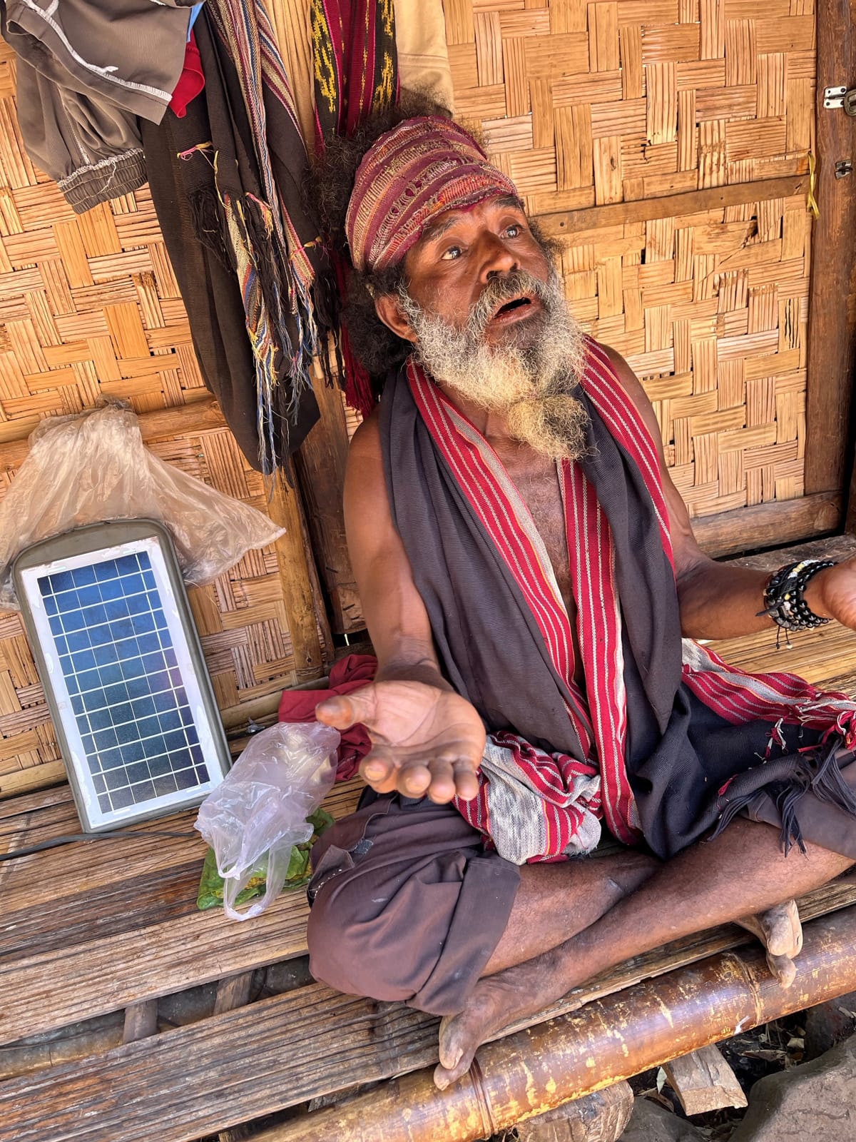 A village elder in Alor, Eastern Indonesia, charges his phone with his own personal solar panel (Stephen Grenville)