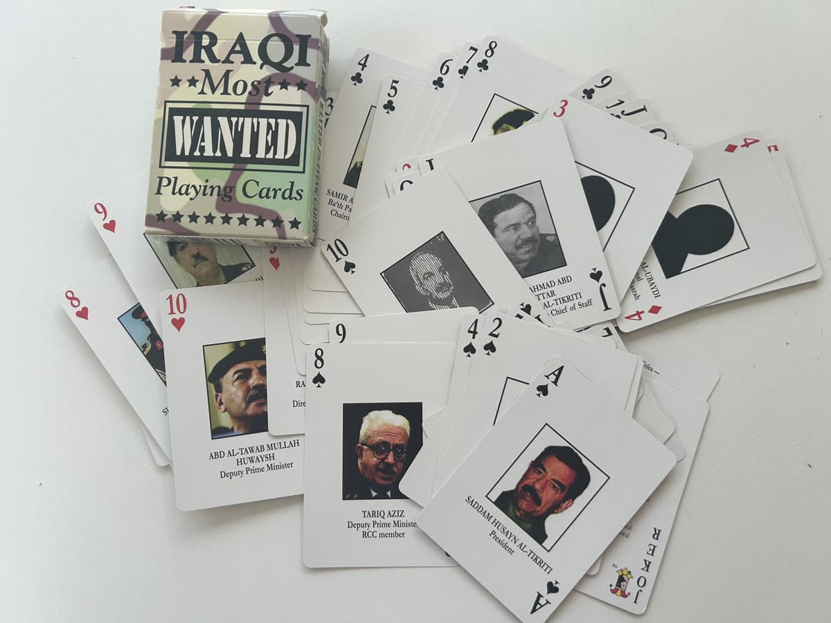 A scattered collection of Most Wanted cards identifying members of the Iraqi regime