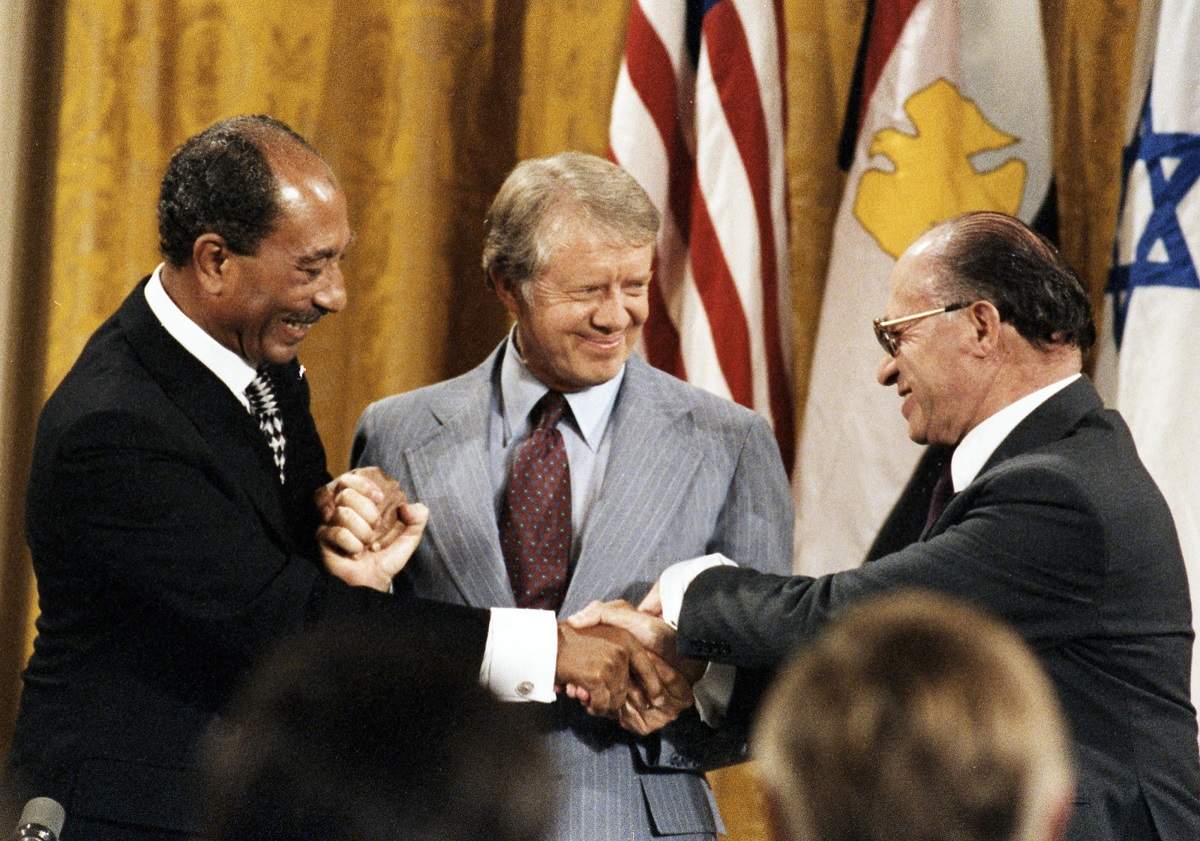 In 1978 at Camp David, Jimmy Carter (C) brokered an agreement between Egypt’s President Anwar Sadat (L) and Israel’s President Menachem Begin (R) in which the two nations pledged to end three decades of war (Jimmy Carter Library/US Govt/Flickr)